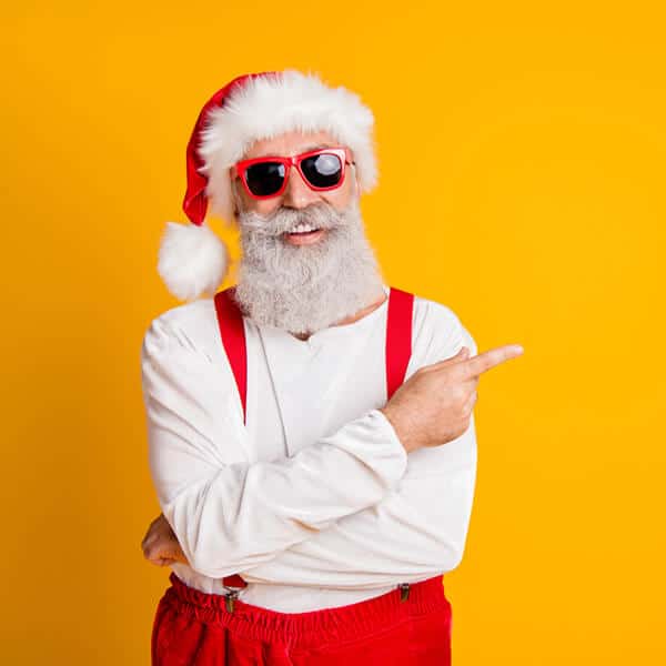 Funky santa wearing sunglasses and pointing