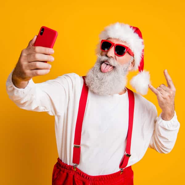Santa in sun glasses posing for a selfie