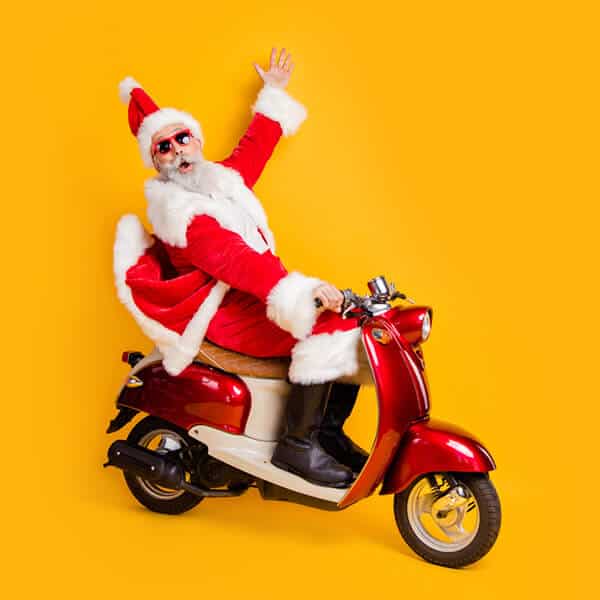 Santa sitting on a moped