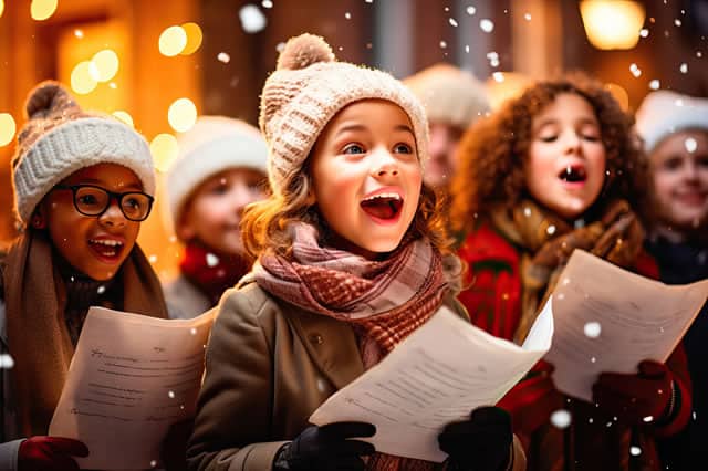 Kids singing traditional christmas songs in the snow